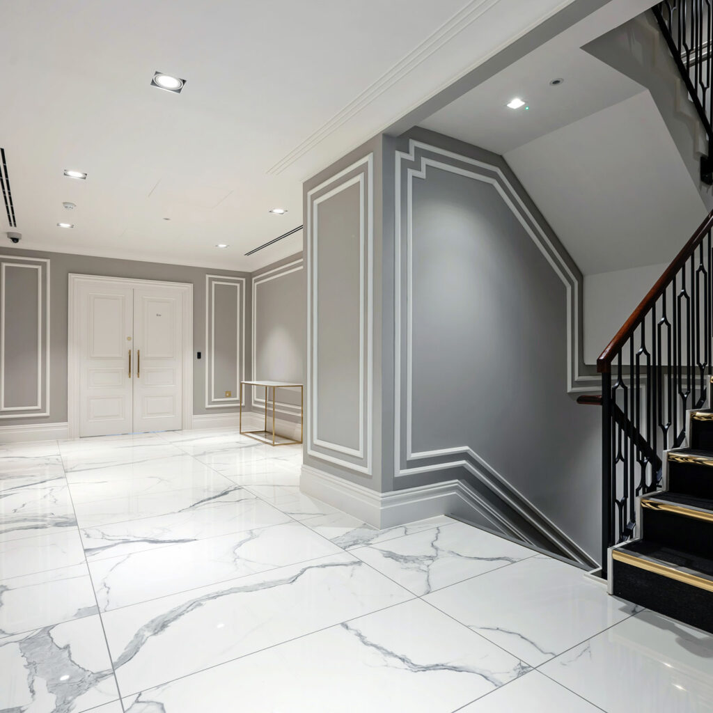 Luxury grey, white and marble office hallway designed by Arke square format