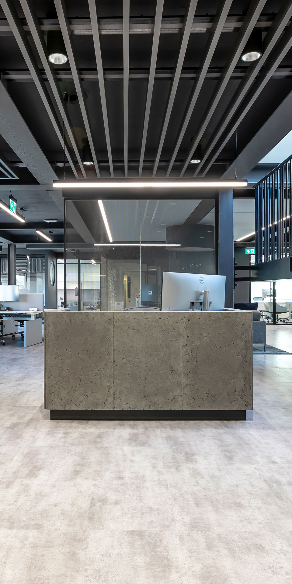 Grey industrial styled reception desk in a London based office, design by Arke