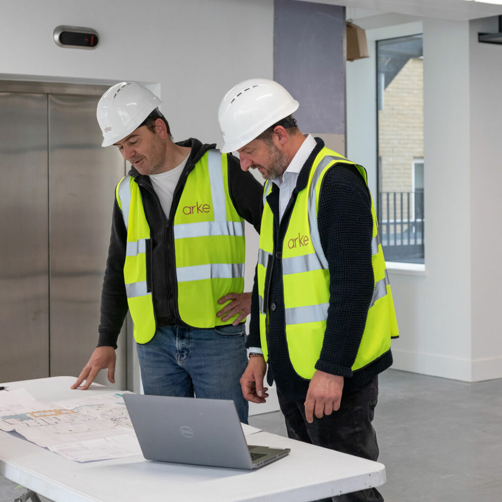 Arke builders discussing office floorplans